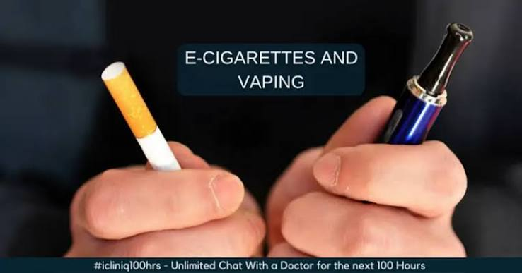 Hands holding a combustible tobacco cigarette in one hand and a blue vape pen in the other with text reading E-Cigarettes and Vaping - E Cig vs Smoking guide by VapeFeat